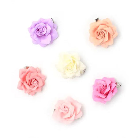 Clip / Small pastel coloured fabric rose on a beak clip.